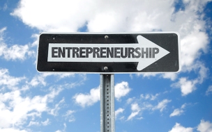 Entrepreneurship direction sign with sky background